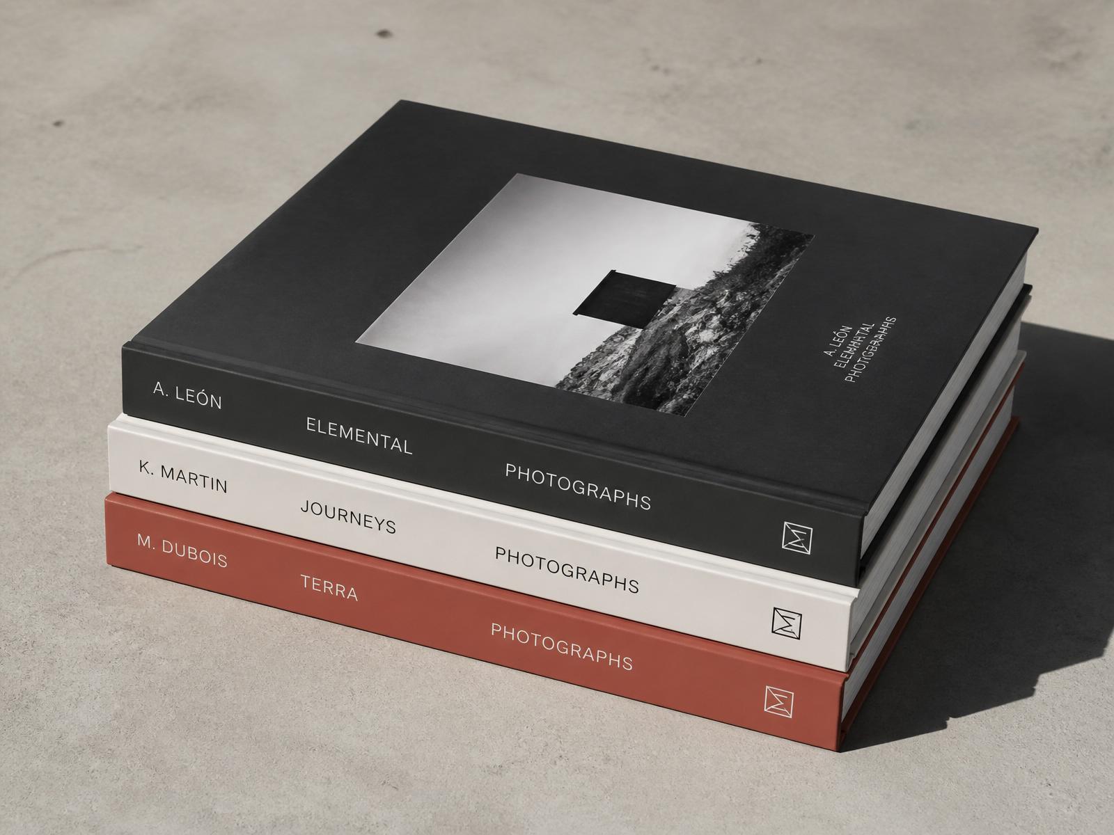 Stack of three premium linen-bound heirloom photo books in cream, sage, and oxblood