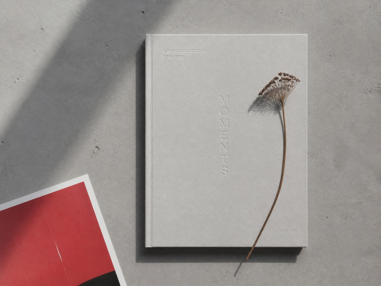 Open heirloom photo book with vintage family photographs and dried botanicals